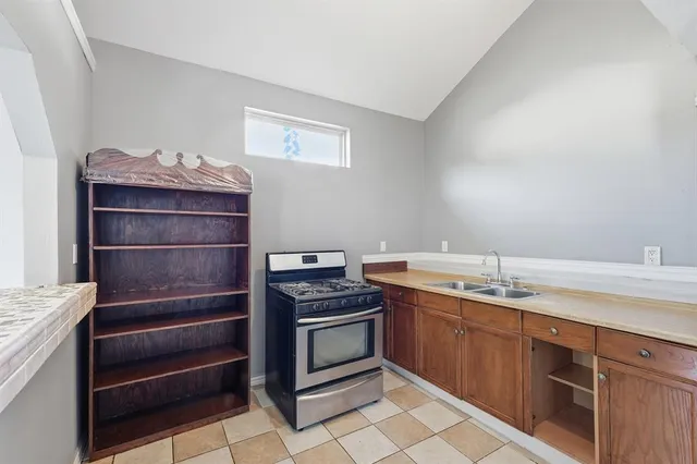 a kitchen with a stove and cabinets