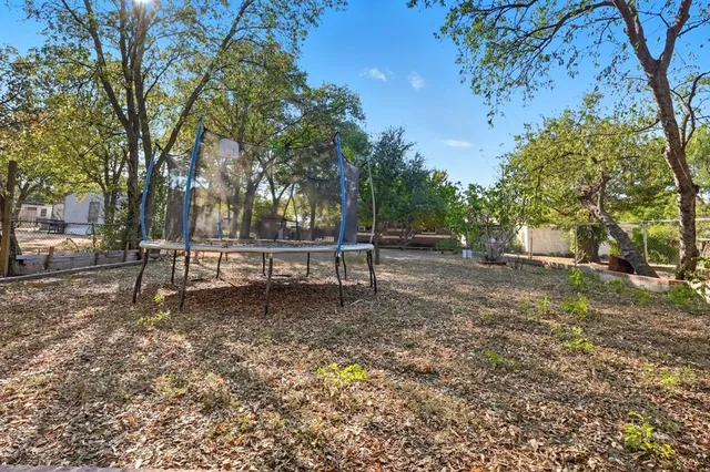 a white bench sitting in middle of a yard