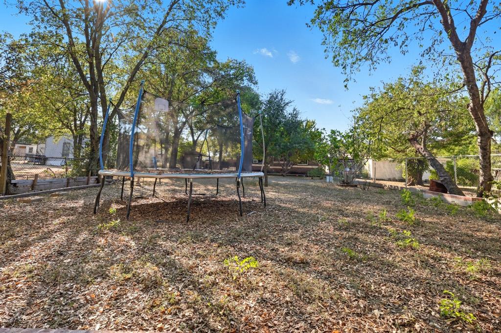 3604 Waters Street Lancaster, TX 75134 - Photo 15 of 15 a white bench sitting in middle of a yard