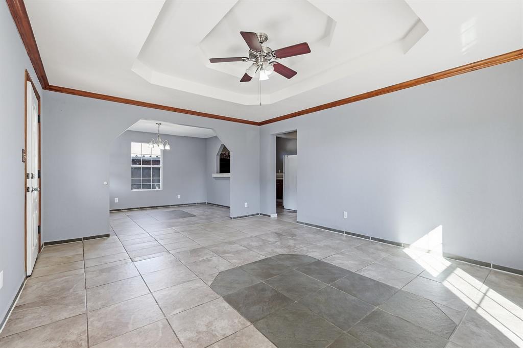 3604 Waters Street Lancaster, TX 75134 - Photo 6 of 15 a view of an empty room with a ceiling fan and window