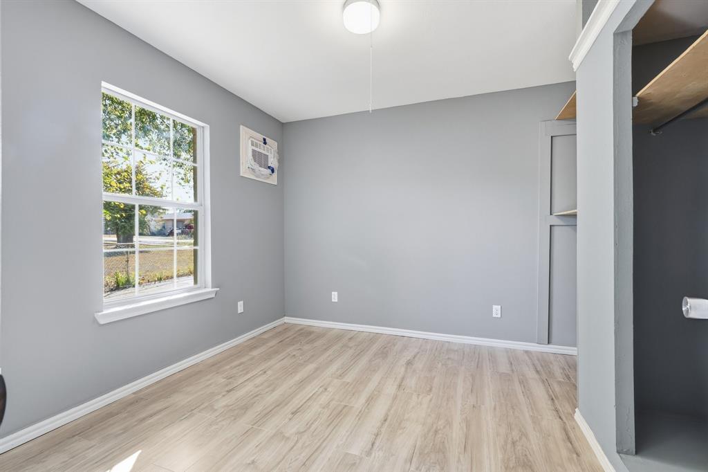 3604 Waters Street Lancaster, TX 75134 - Photo 8 of 15 a view of an empty room with wooden floor and a window