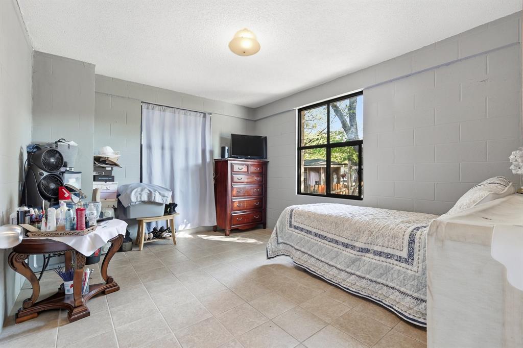 3604 Waters Street Lancaster, TX 75134 - Photo 10 of 15 a bed room with a bed and a chair