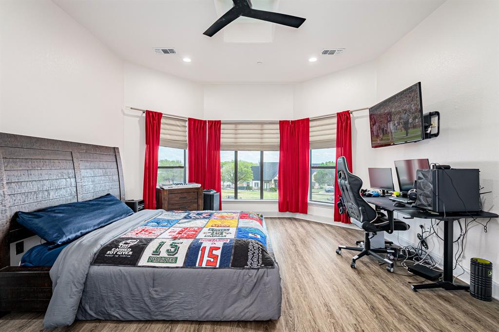 1091 Broadmoor Lane Prosper, TX 75078 - Photo 24 of 39 a bedroom with a bed and wooden floor