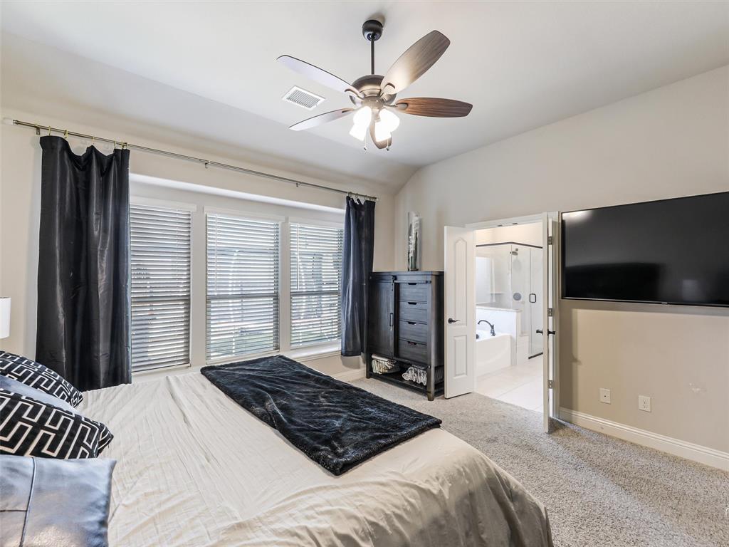 1216 Tree Shadow Lane Anna, TX 75409 - Photo 17 of 37 a bedroom with a large bed and a flat tv screen