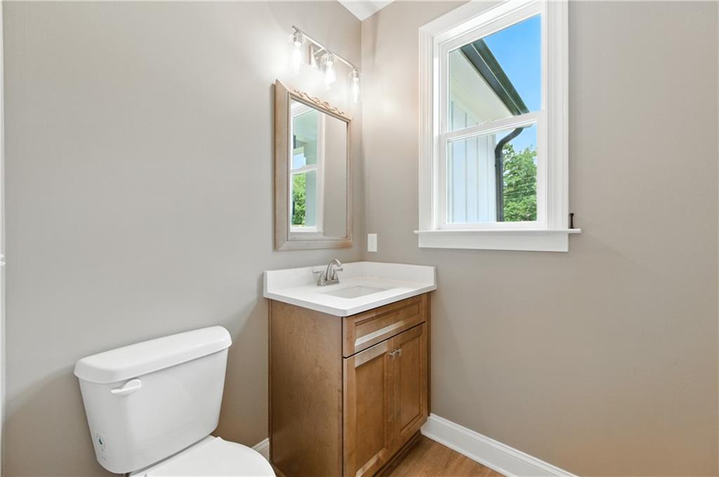 5119 Yellow Creek Road Ball Ground, GA 30107 - Photo 23 of 48 a bathroom with a toilet sink and mirror