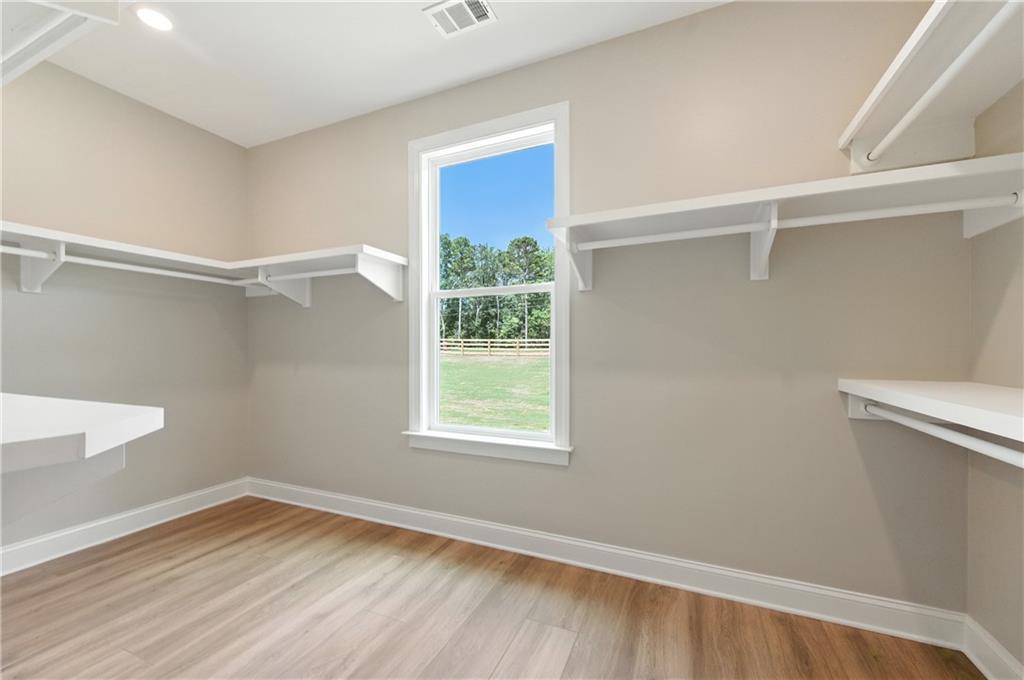 5119 Yellow Creek Road Ball Ground, GA 30107 - Photo 27 of 48 a view of an empty room with wooden floor and a window