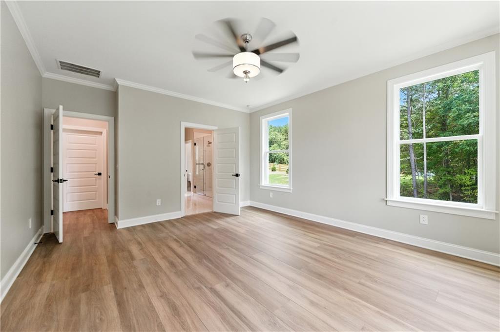 5119 Yellow Creek Road Ball Ground, GA 30107 - Photo 30 of 48 a view of an empty room with a window and wooden floor