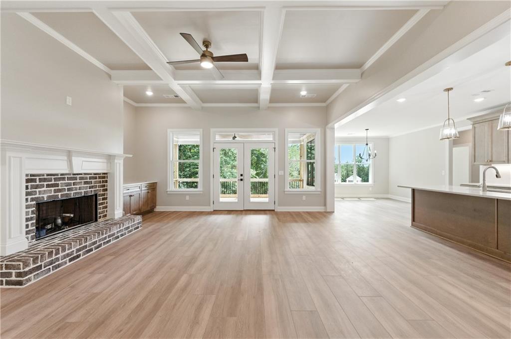 5119 Yellow Creek Road Ball Ground, GA 30107 - Photo 8 of 48 wooden floor fireplace and windows in an empty room