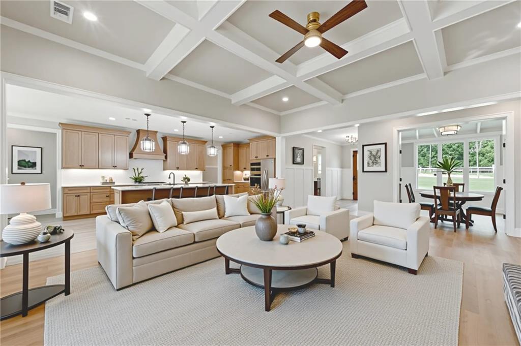5119 Yellow Creek Road Ball Ground, GA 30107 - Photo 10 of 48 a living room with furniture and a dining table with kitchen view
