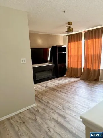 a view of room with window and hardwood floor