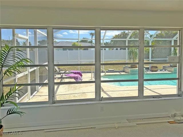 a bedroom with a large bed and a large window