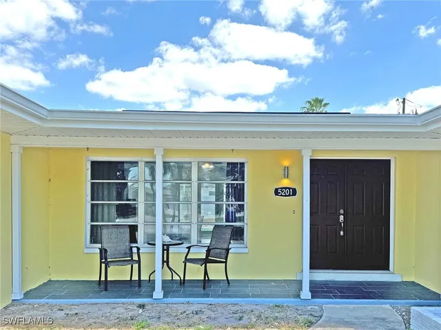a view of swimming pool with outdoor seating