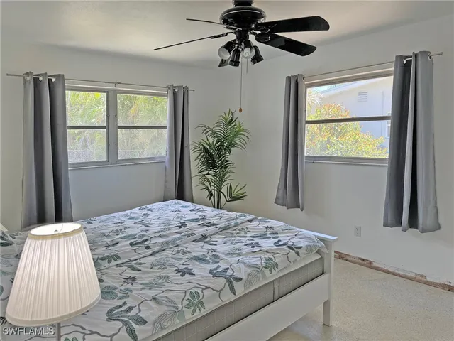 a bed sitting in a bedroom next to a window