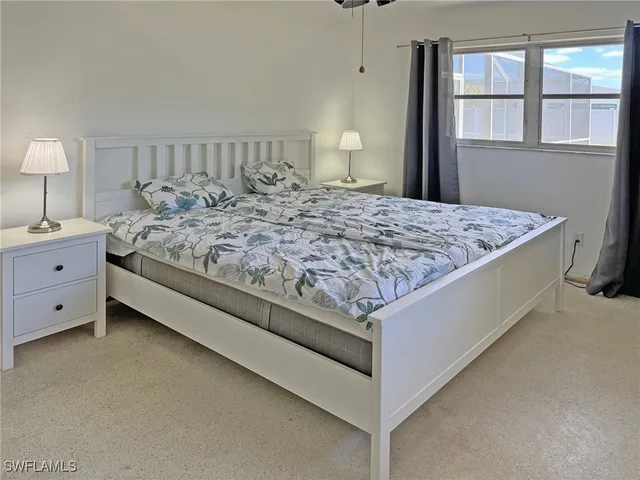 a bedroom with a bed and a table