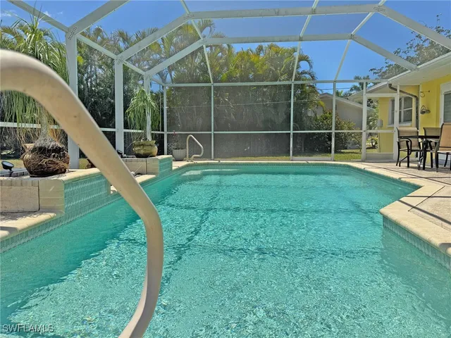 a view of a swimming pool with a yard