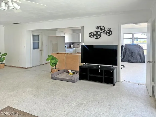 a kitchen with a sink cabinets appliances and a window