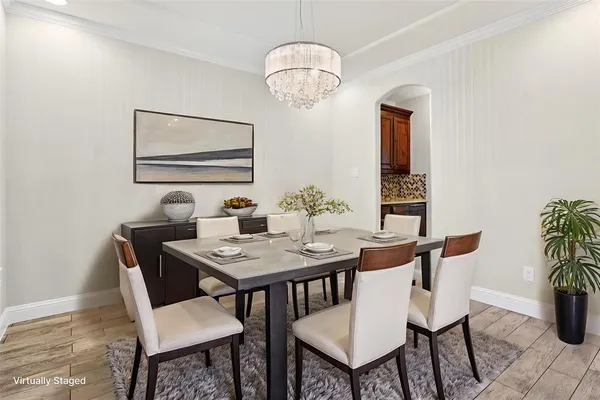 a dining room with furniture and chandelier