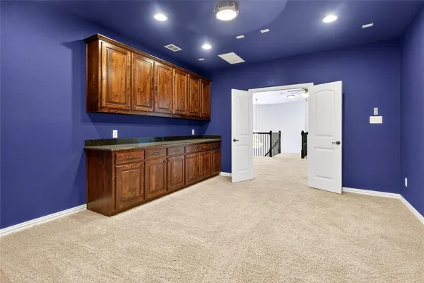 a view of a livingroom with kitchen and furniture