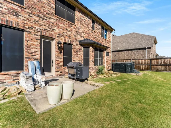 a view of a house with backyard sitting area and tub
