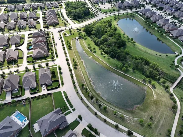 an aerial view of a residential houses with outdoor space and street view