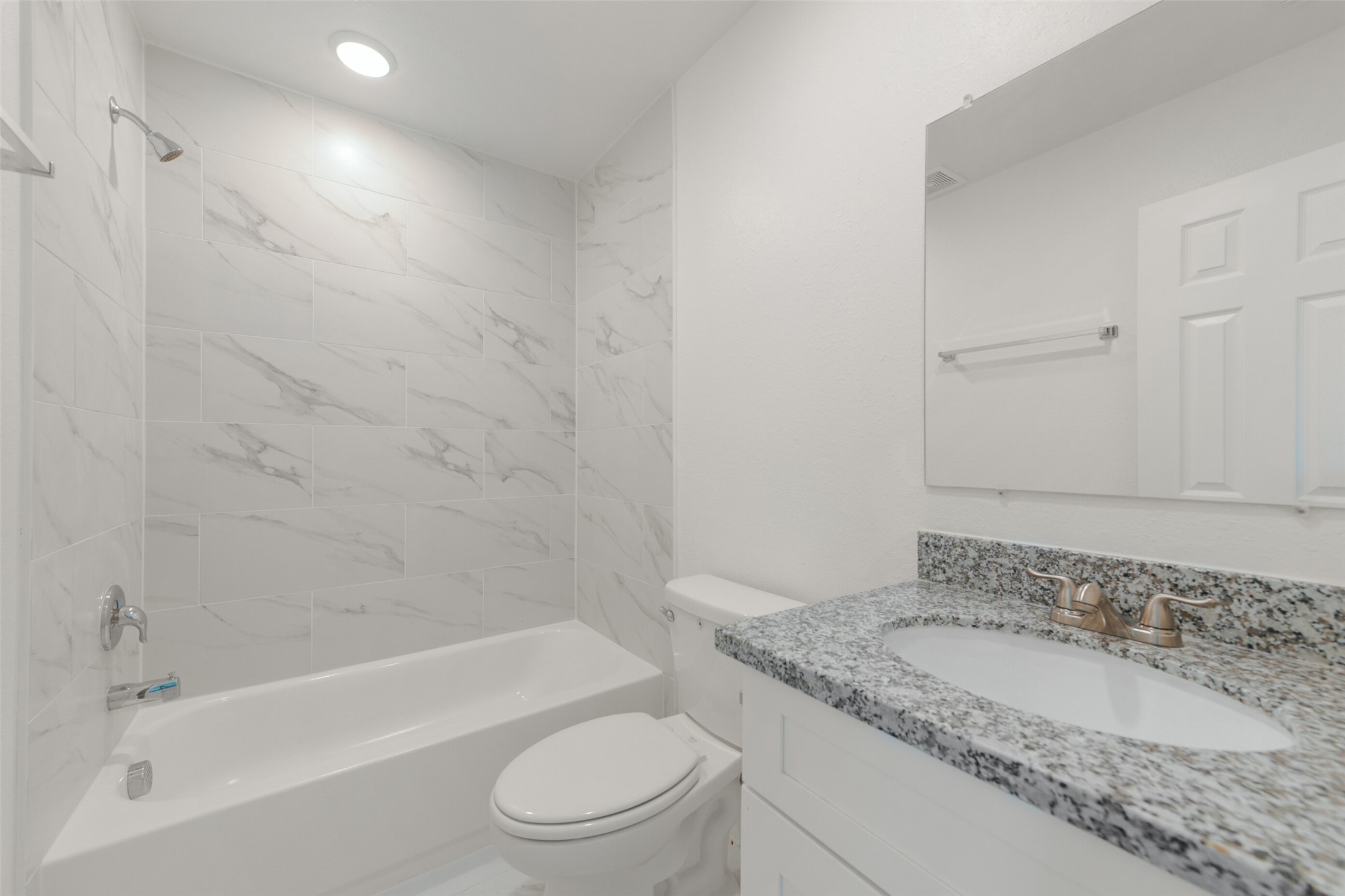 8713 Southwark Street, Unit B Houston, TX 77028 - Photo 11 of 17 a bathroom with a granite countertop sink toilet and shower