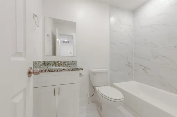 a bathroom with a sink a toilet and bathtub