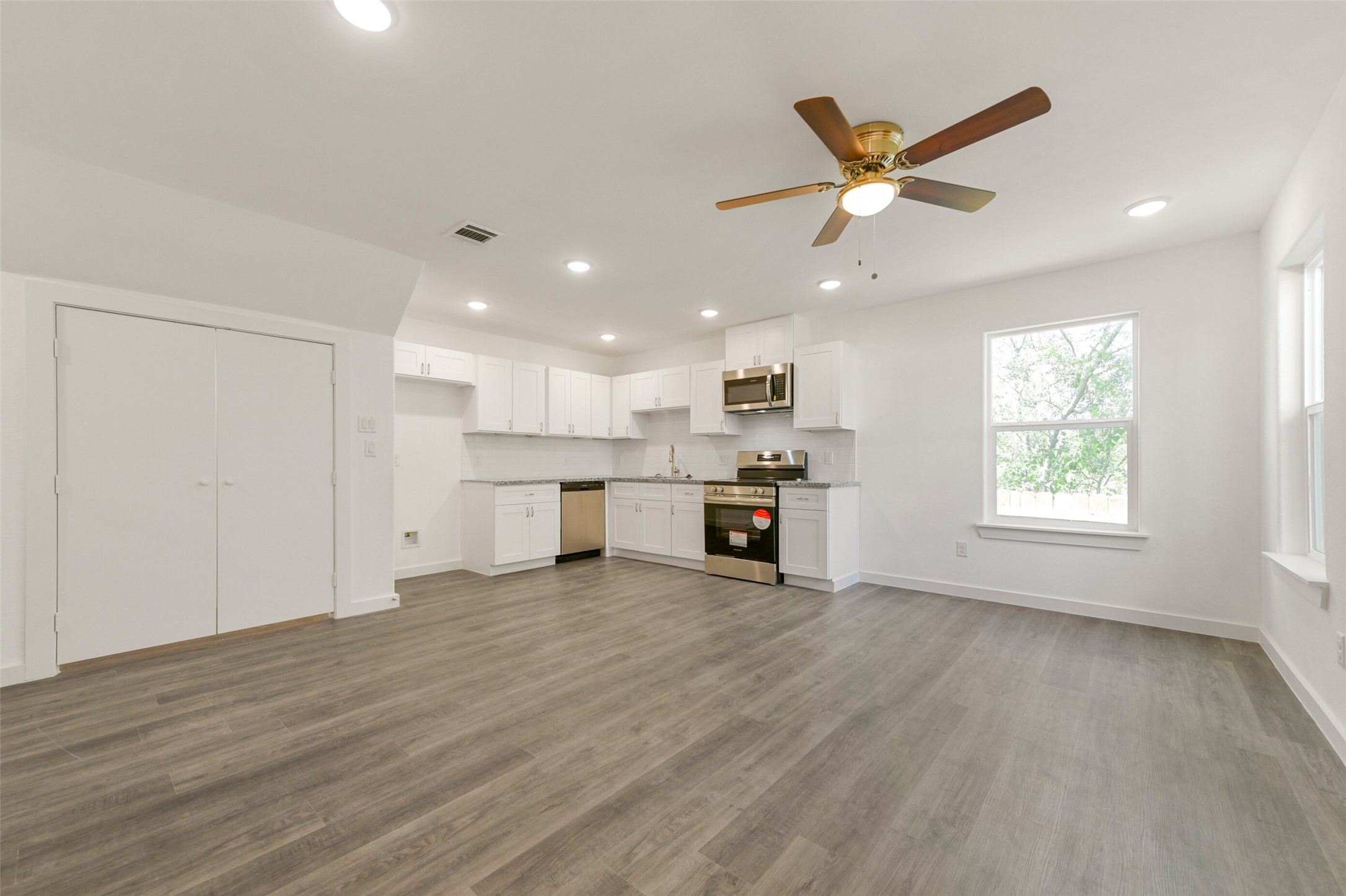 8713 Southwark Street, Unit B Houston, TX 77028 - Photo 2 of 17 a view of an empty room with kitchen appliances and a window