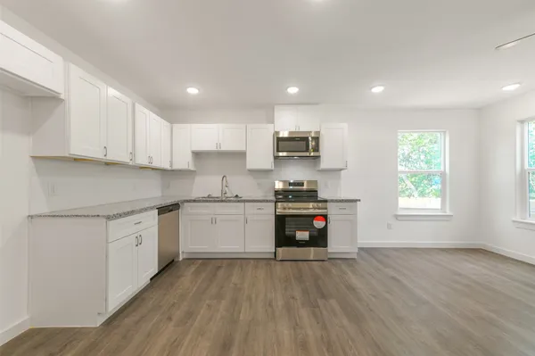 a kitchen with stainless steel appliances a refrigerator sink and stove