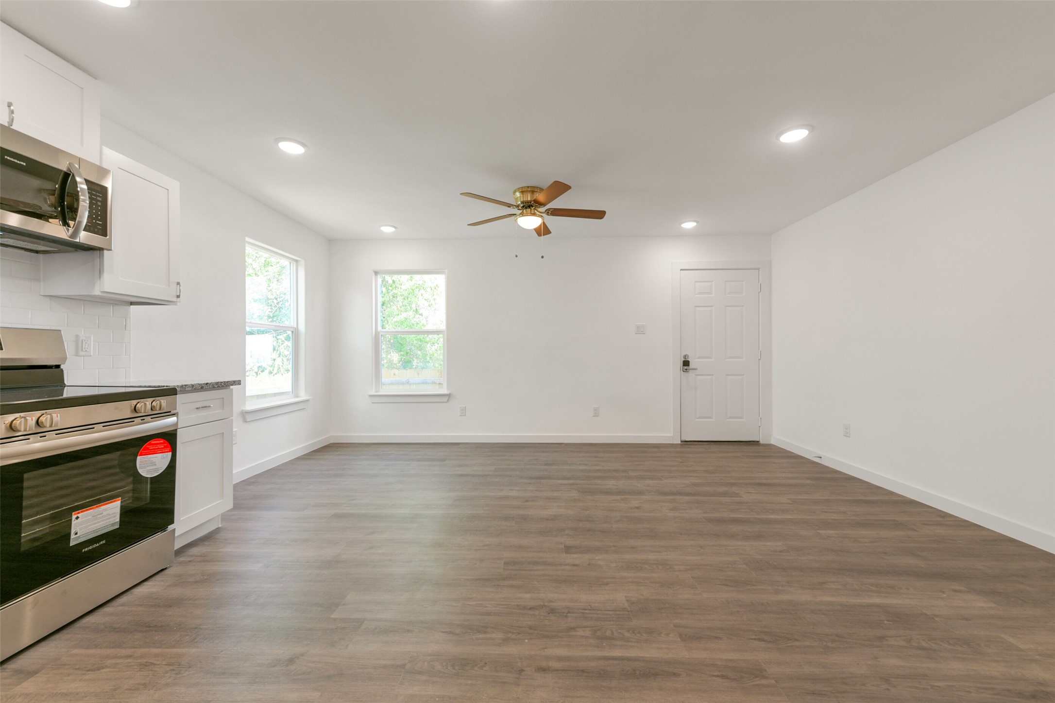 8713 Southwark Street, Unit B Houston, TX 77028 - Photo 7 of 17 a view of an empty room with a window and a kitchen