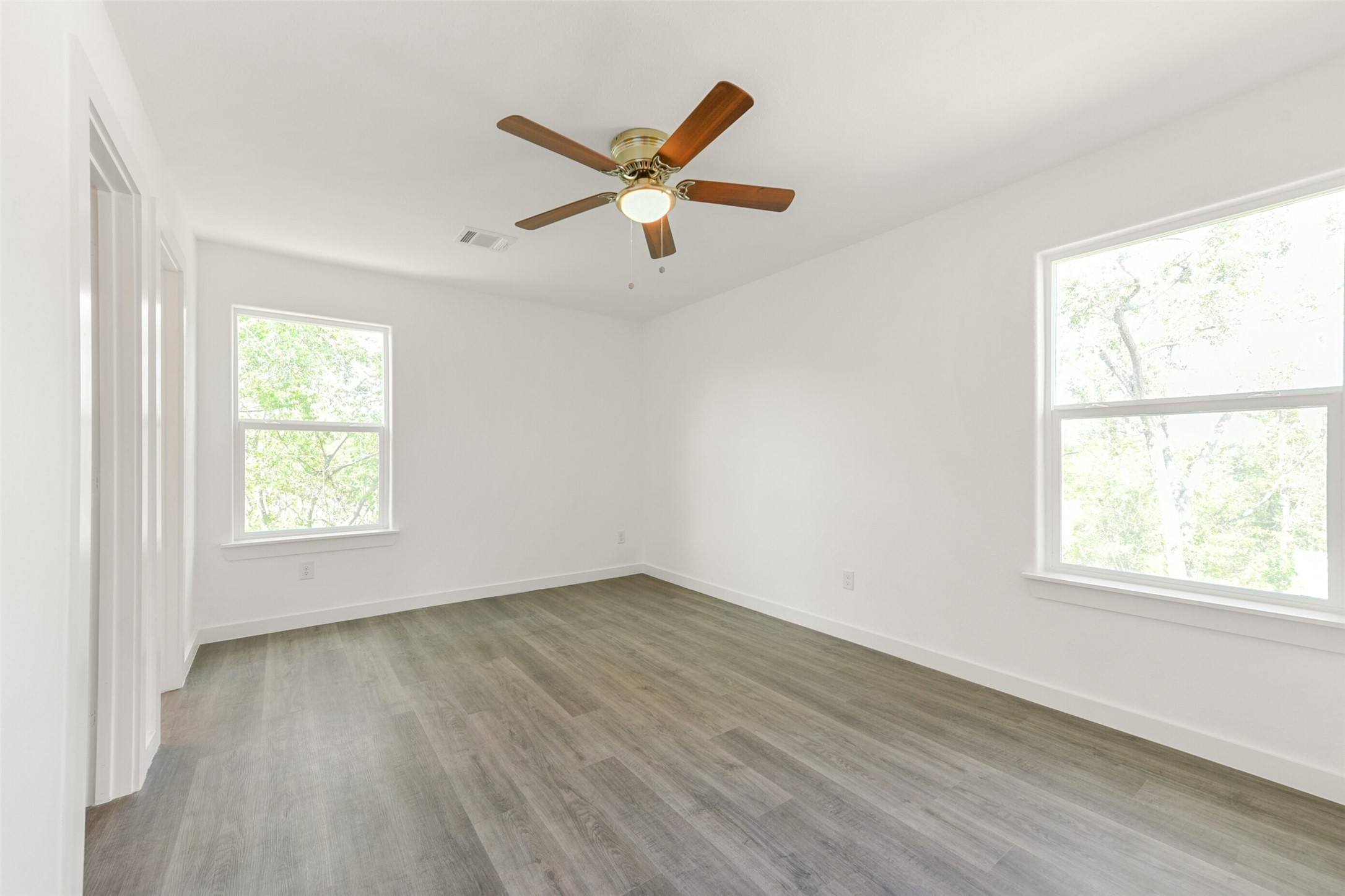 8713 Southwark Street, Unit B Houston, TX 77028 - Photo 9 of 17 a view of empty room with wooden floor and fan