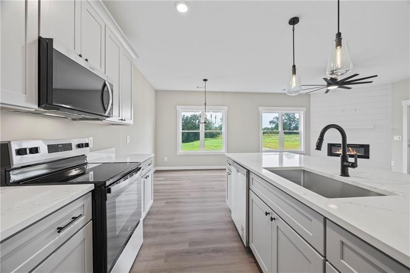 693 Racetrack Road Toccoa, GA 30577 - Photo 21 of 45 a kitchen with stainless steel appliances a sink a stove and microwave
