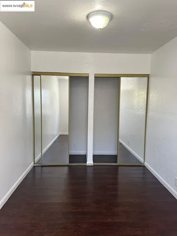 an empty room with wooden floor