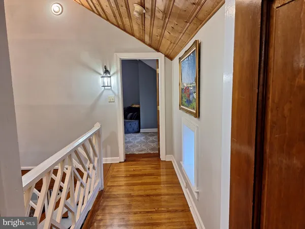 a view of hallway with wooden floor