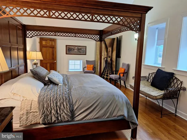 a bed sitting in a bedroom next to a window