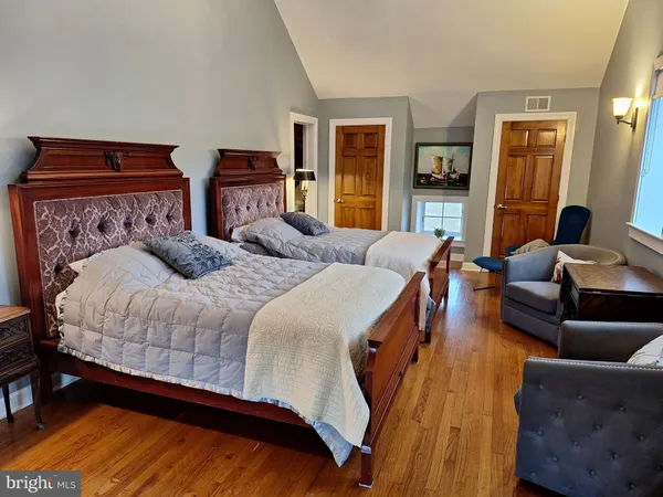 a bedroom with two beds and a couch