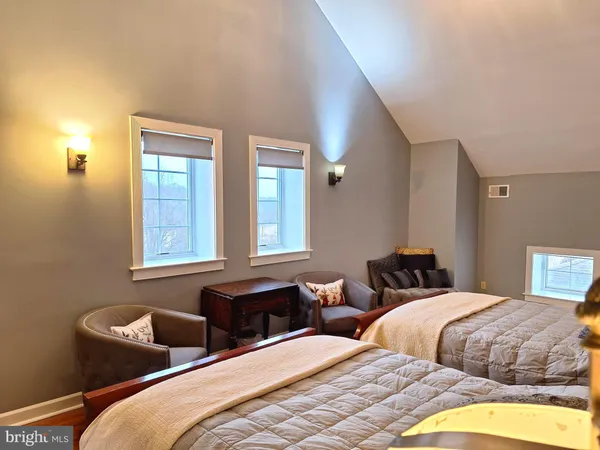 a bedroom with two beds and painted walls