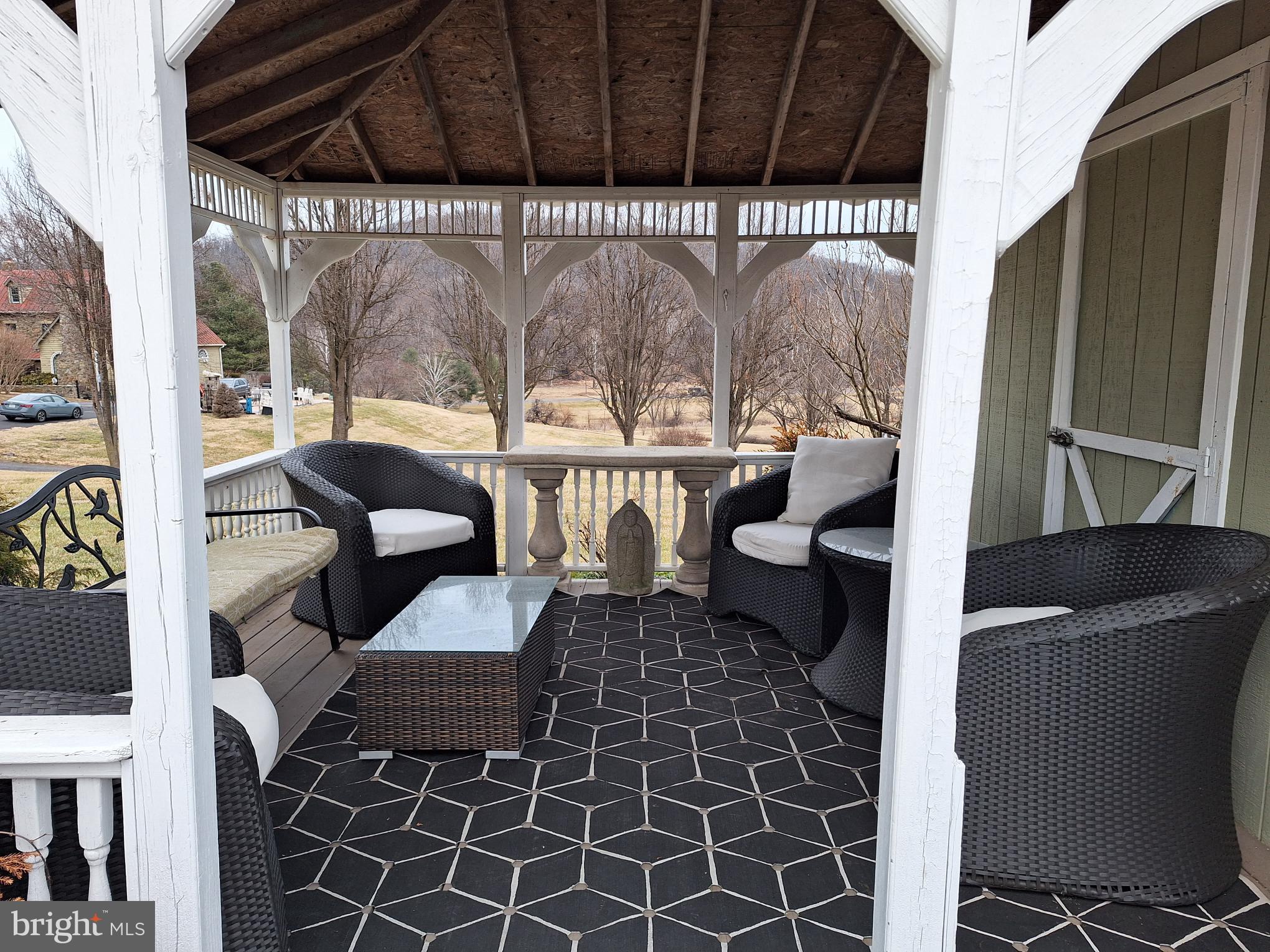 2254 Winchester Road Delaplane, VA 20144 - Photo 43 of 50 a view of a chairs and table in patio with wooden fence