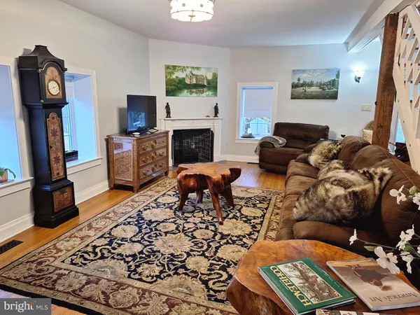 a living room with furniture a flat screen tv and a fireplace