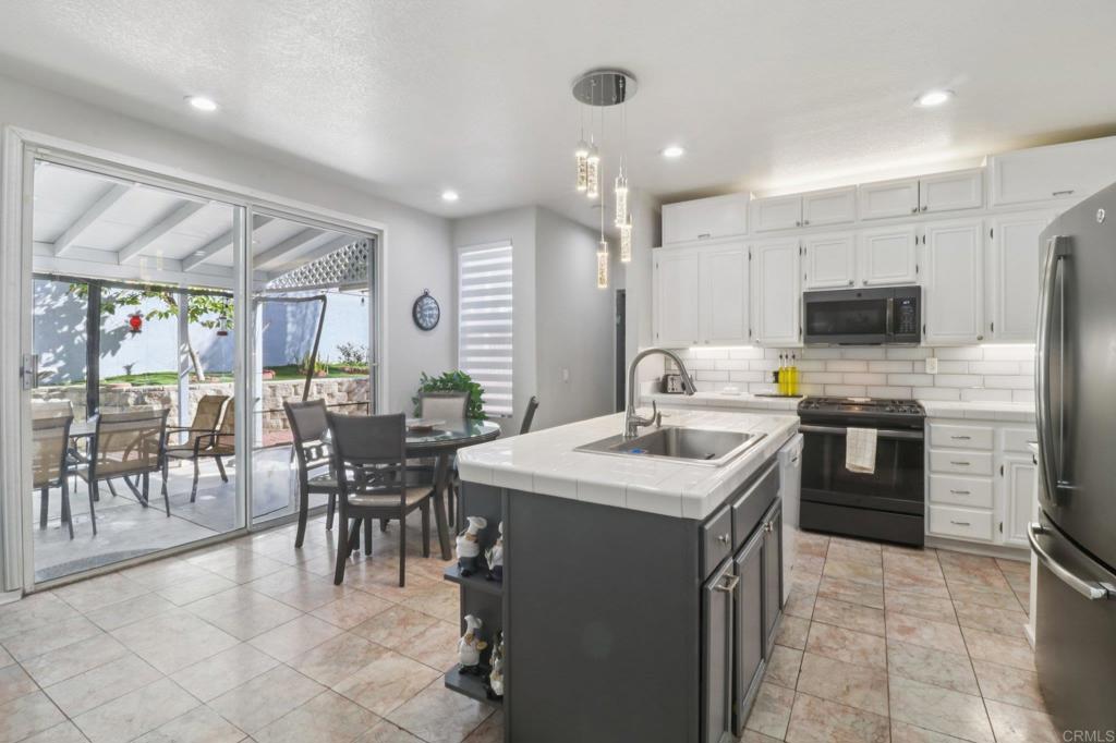 232 Manzanilla Way Oceanside, CA 92057 - Photo 13 of 35 a kitchen with a sink a counter top stainless steel appliances and cabinets