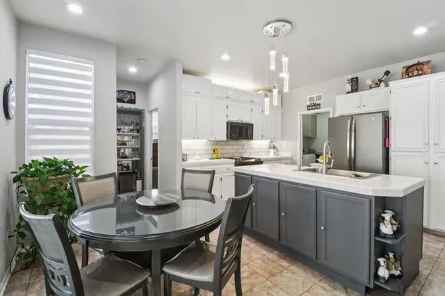 a kitchen with a table and chairs in it