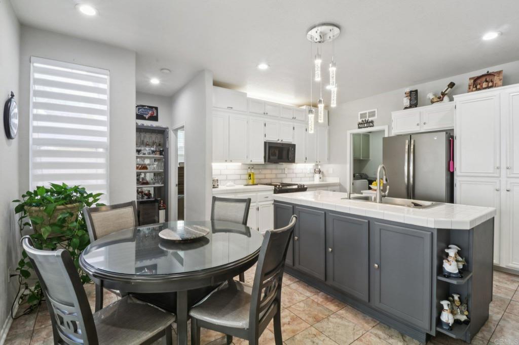 232 Manzanilla Way Oceanside, CA 92057 - Photo 14 of 35 a kitchen with a table and chairs in it