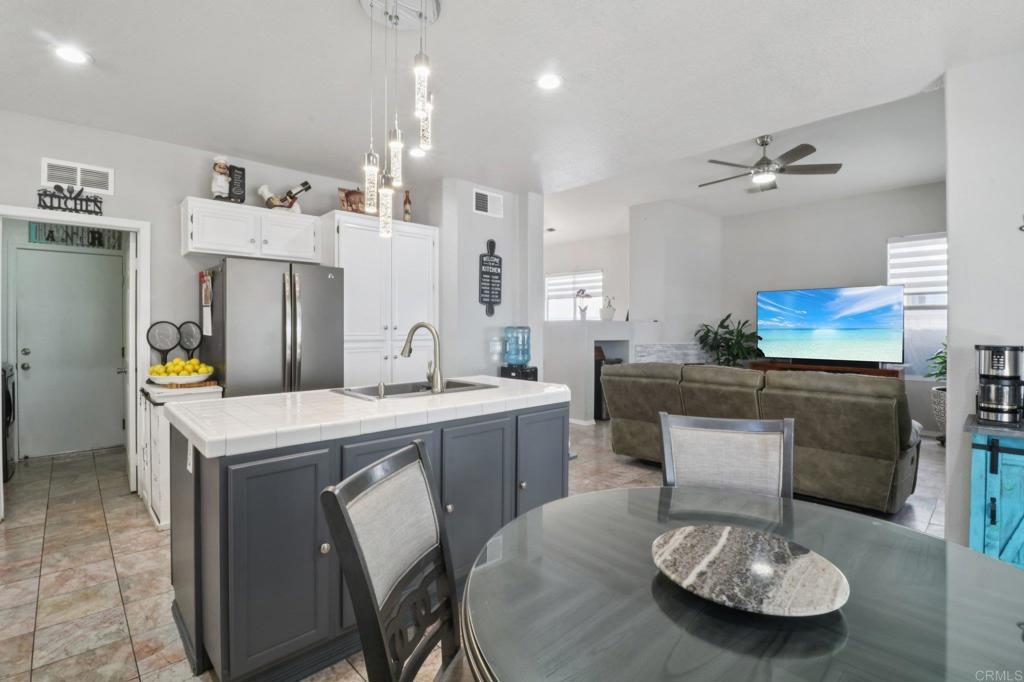 232 Manzanilla Way Oceanside, CA 92057 - Photo 15 of 35 a kitchen that has a table and chairs in it