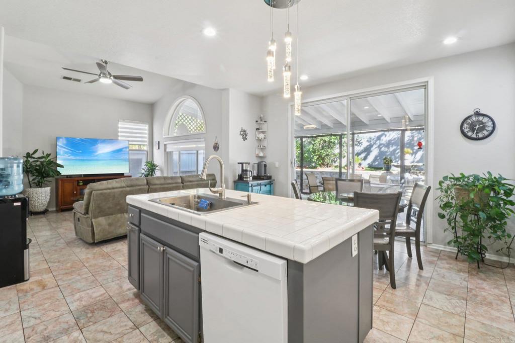 232 Manzanilla Way Oceanside, CA 92057 - Photo 16 of 35 a kitchen with a table chairs and a clock