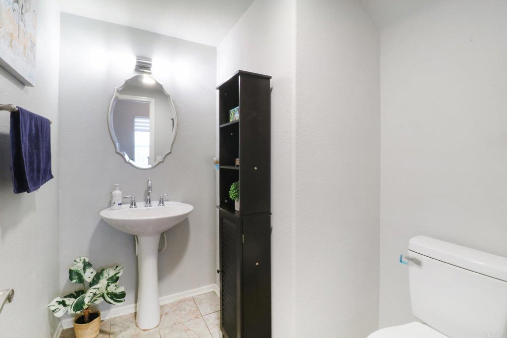 232 Manzanilla Way Oceanside, CA 92057 - Photo 18 of 35 a bathroom with a sink and a mirror