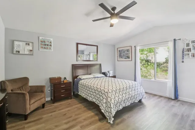 a bedroom with a bed window and couch