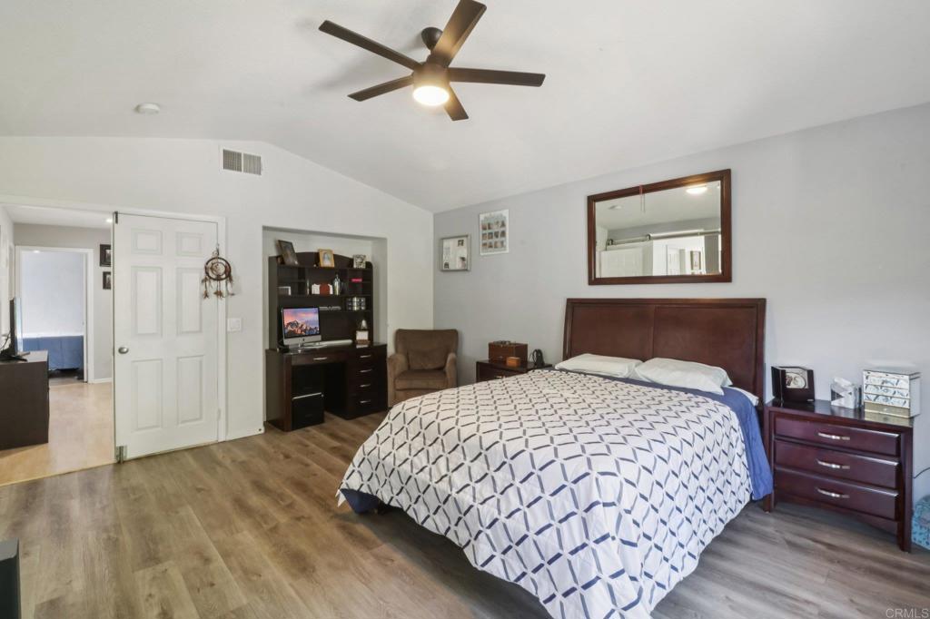 232 Manzanilla Way Oceanside, CA 92057 - Photo 22 of 35 a bedroom with a bed and wooden floor