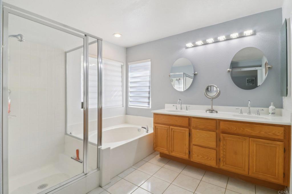 232 Manzanilla Way Oceanside, CA 92057 - Photo 24 of 35 a spacious bathroom with a double vanity sink mirror and bathtub