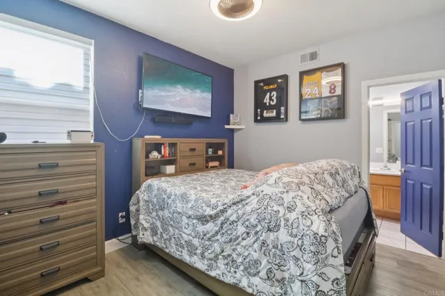 a bedroom with a bed and a dresser