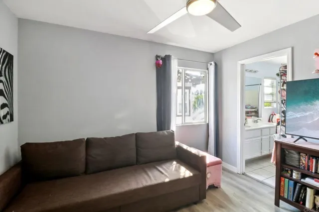 a living room with furniture and a book shelf