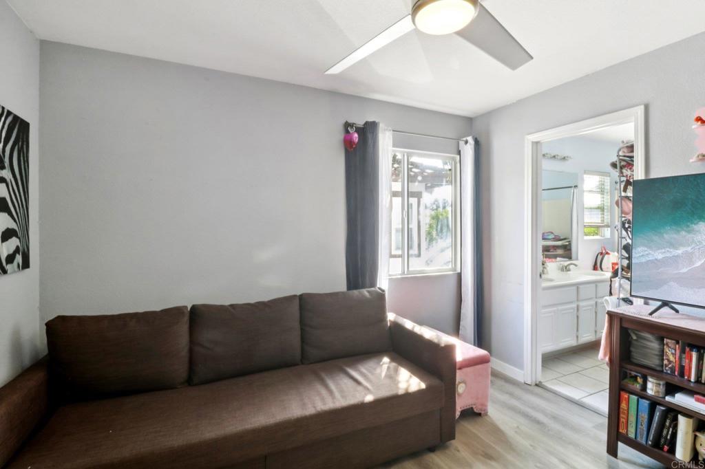 232 Manzanilla Way Oceanside, CA 92057 - Photo 31 of 35 a living room with furniture and a book shelf